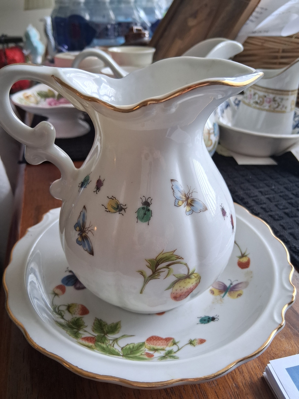 White Porcelain Pitcher with Gold Trim and Floral Butterfly Motif
